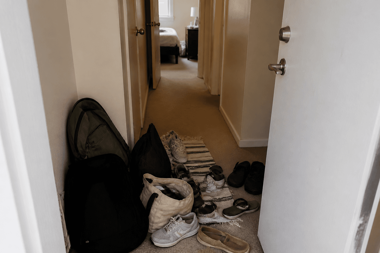 First meter inside a front door with shoes and bags in the swing