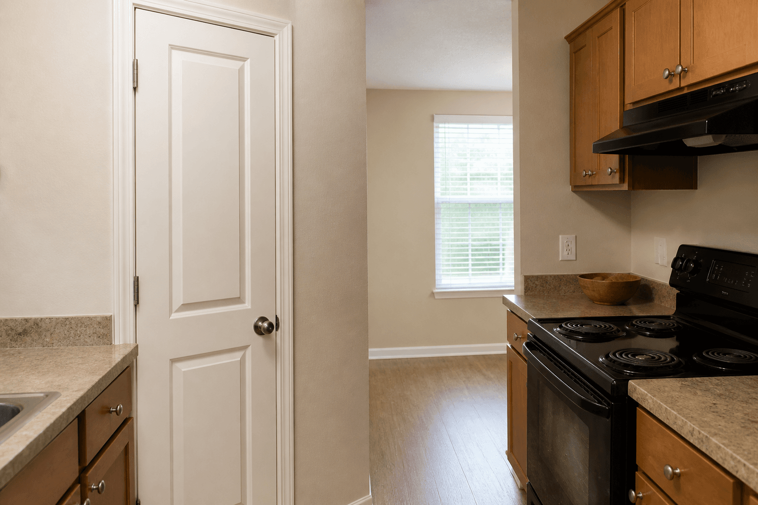 Rental kitchen with a closed pantry cupboard beside the stove and a clear cook aisle, feng shui pantry