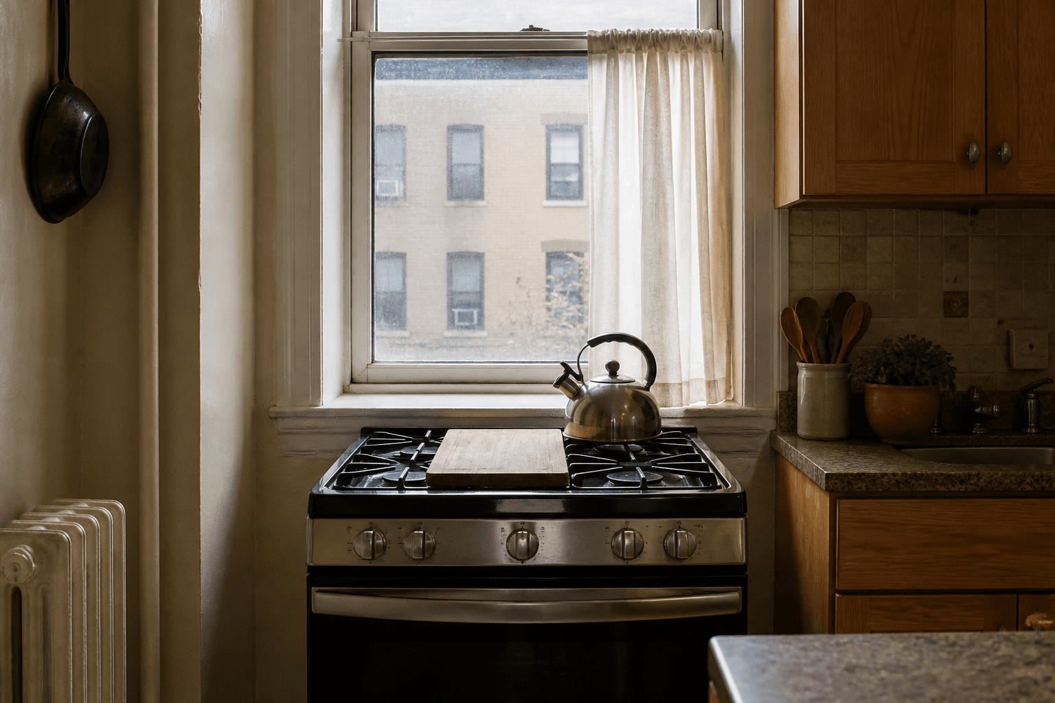 Stainless gas range under a white rental window, wood board on the stove, daylight on the glass, feng shui stove under window