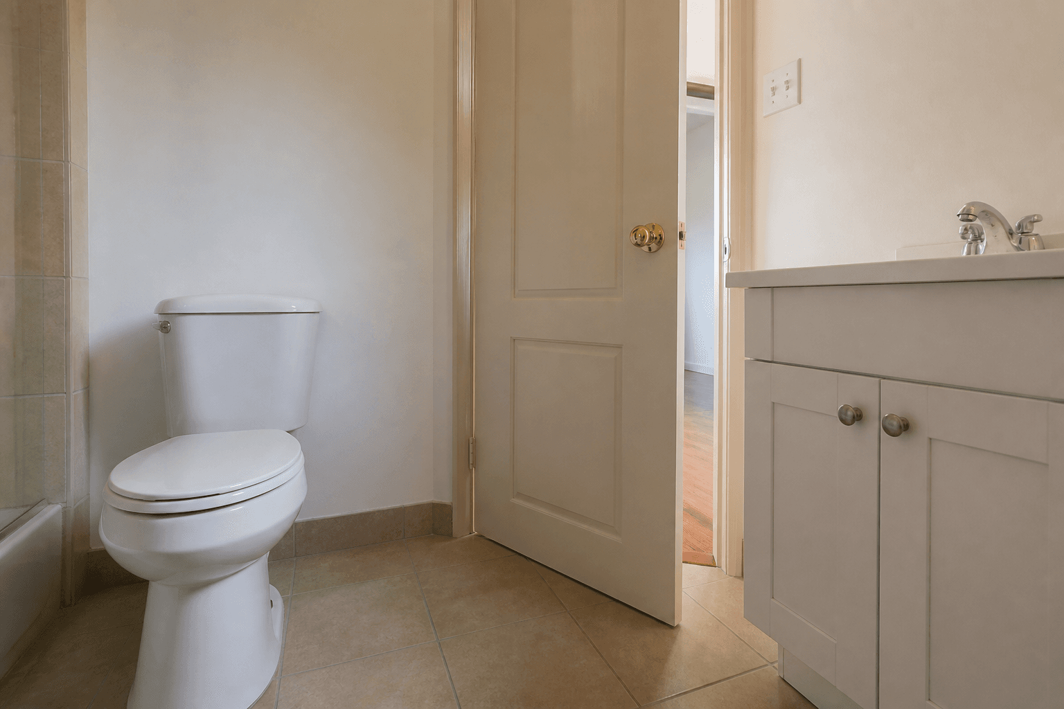 Small upstairs rental bathroom with the toilet lid closed and the door nearly shut, feng shui upstairs toilet