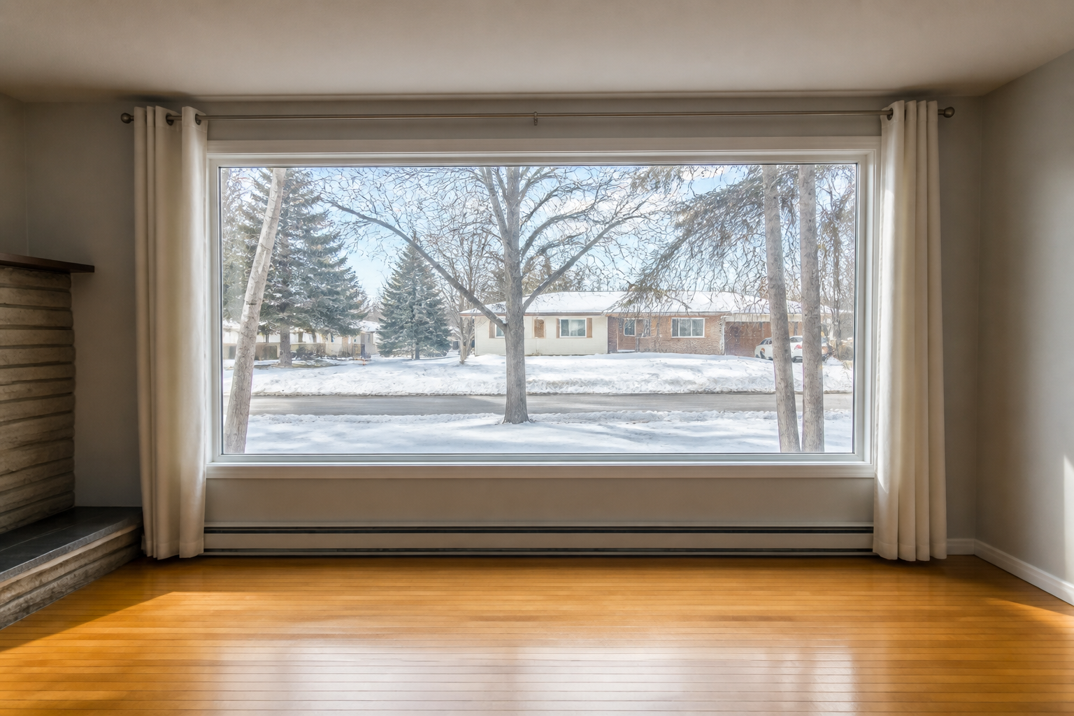 Washed rental window with curtains open to winter daylight