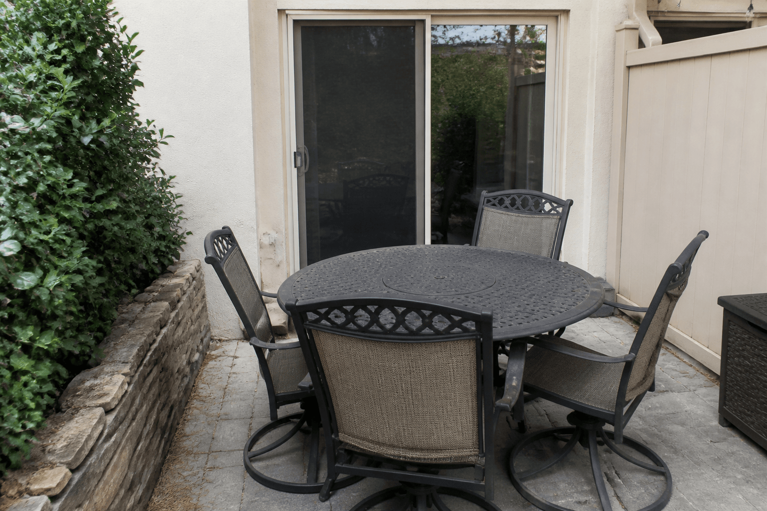 Patio table blocking the path from the yard to the sliding door latch